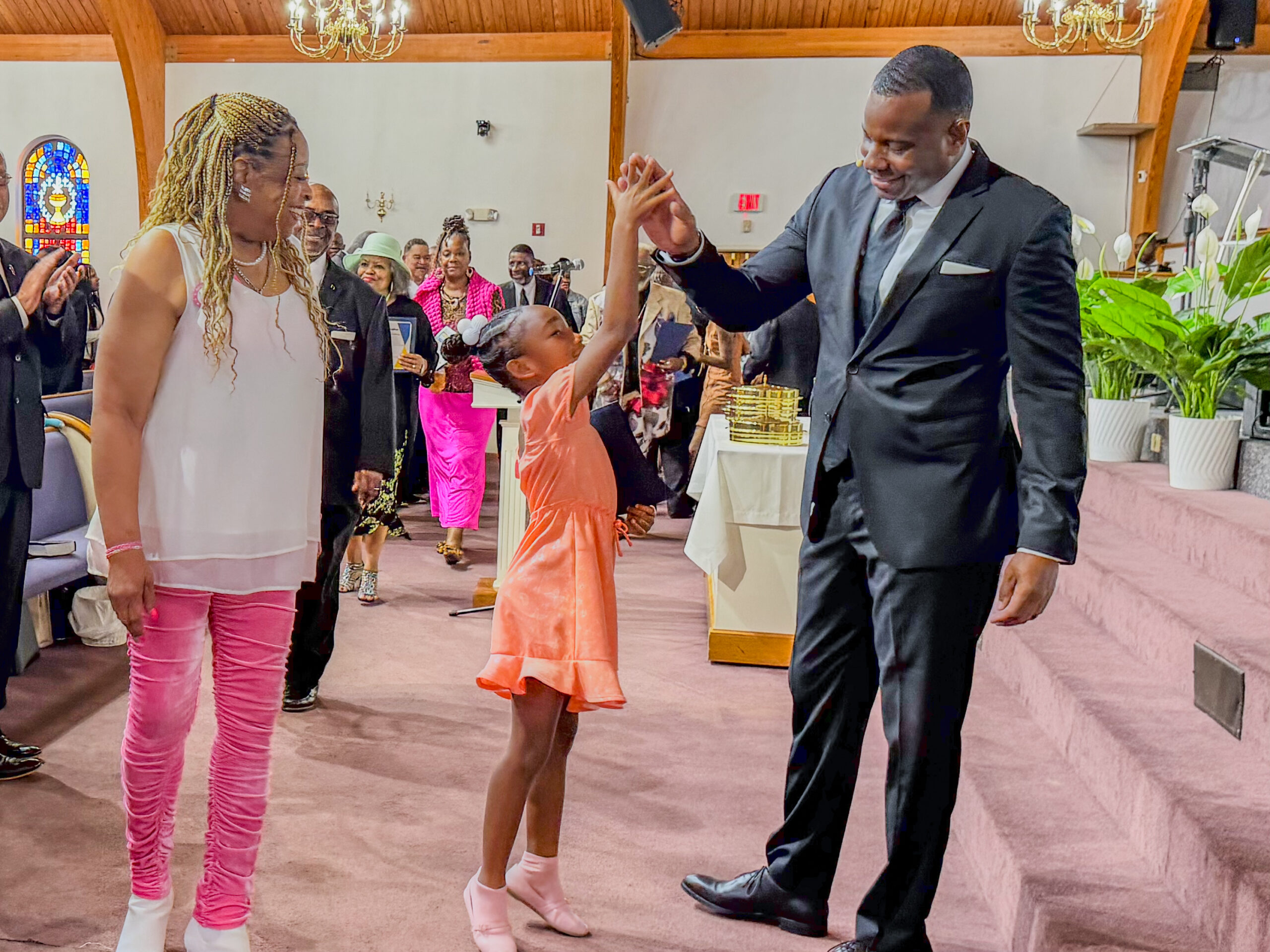 Pastor Terry Brown high-fiving a young member of the church